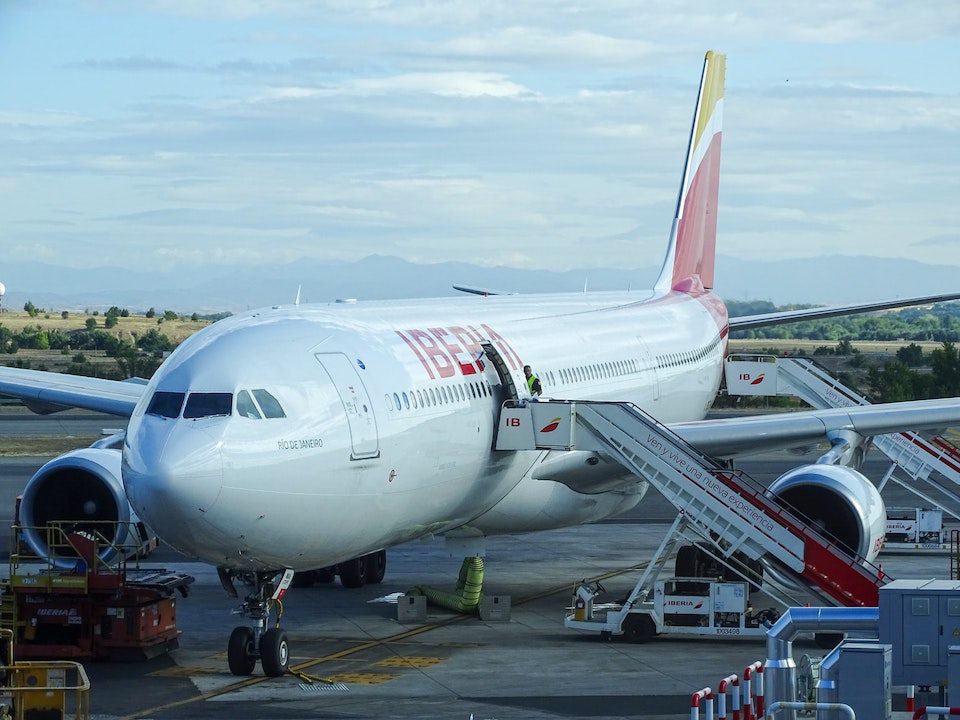 An Iberian Air jet gets loaded with passengers at Madrid International Airport