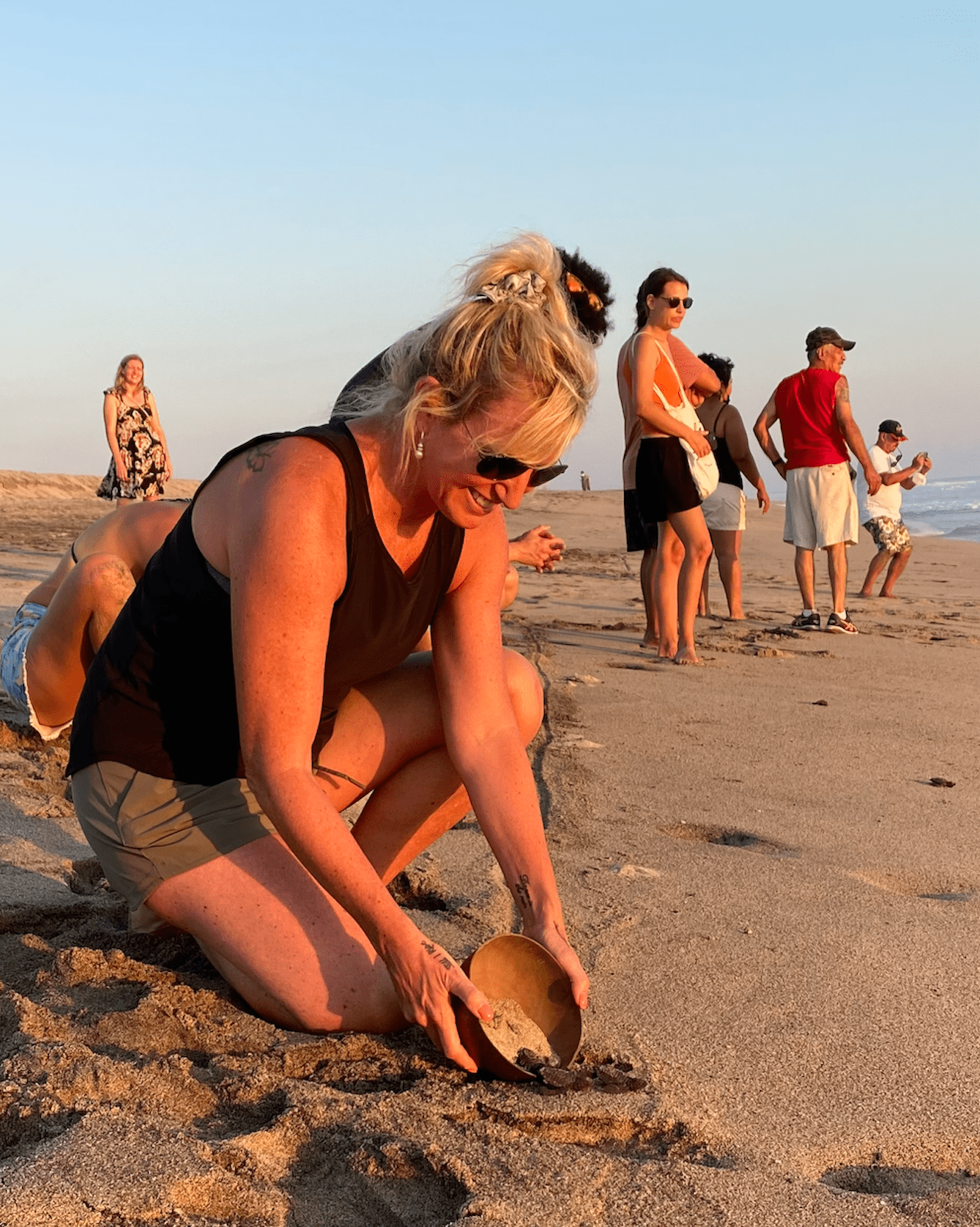 Carolyn releasing a baby sea turtle in Puerto Esondido
