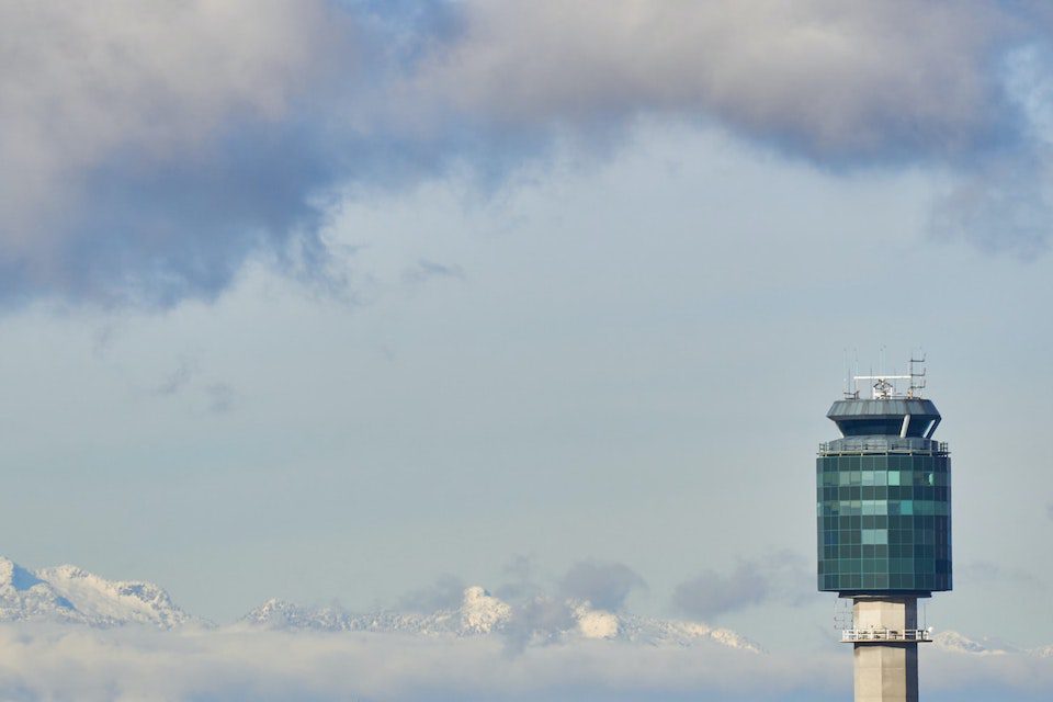 Mountains surrounding the control tower at Vancouver International Airport