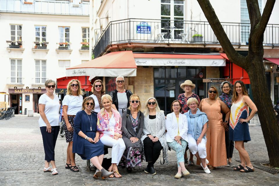 A group of women together for a photo on a tour
