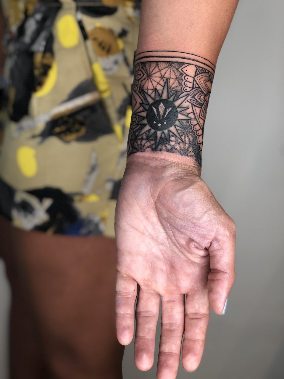 This is a black and grey traditional style Balinese dragon or Naga with a  Balinese style script in the middle in the shape of an arrow. Done by Eka  at Sekala369 Studio,