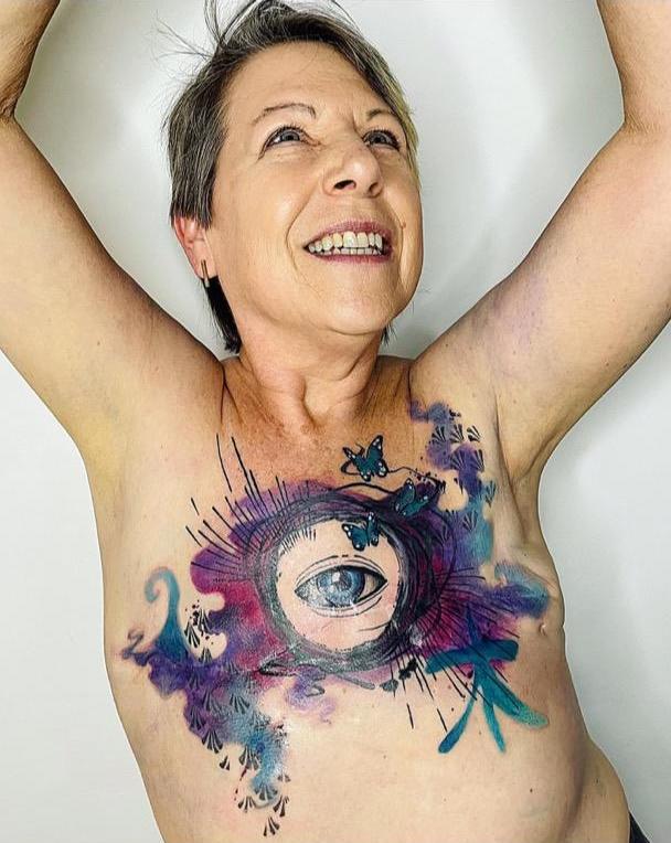 Christine Pope shows off her beautiful chest tattoo after receiving her double masectomy.