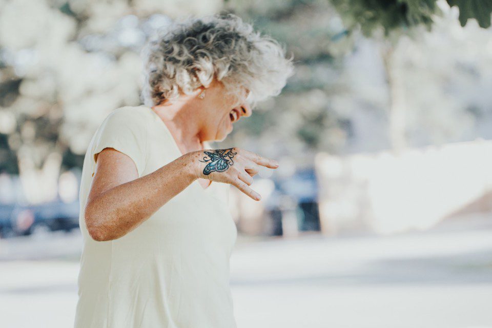 An older woman with a butterfly tattoo