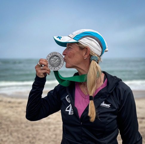  Beth Whitman kisses her medal after completing her run at the Namibia Medal