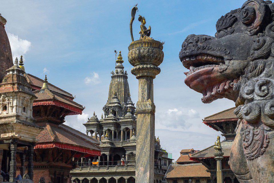 Woman Travellers over 50  looking at Temples and statues in Durbar Square in Patan in Kathmandu, Nepal.