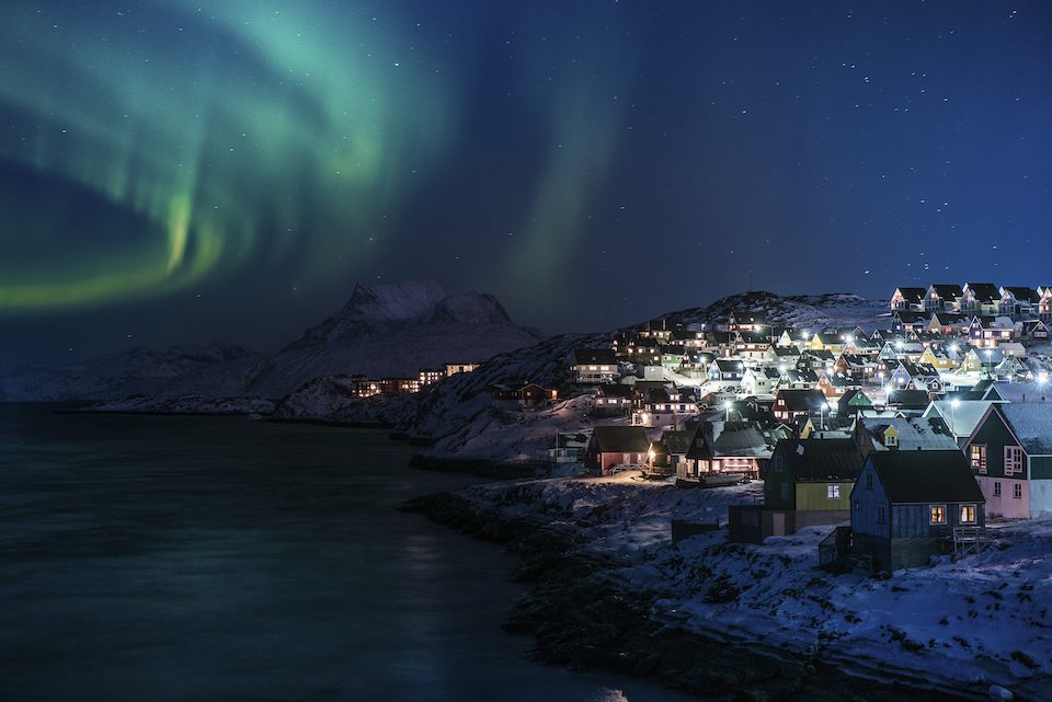 Illuminated houses under the Northern Lights, Nuuk Greenland
