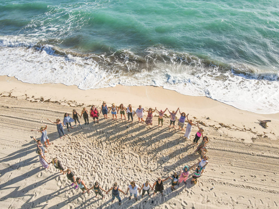 circle of women on beach in Bahamas