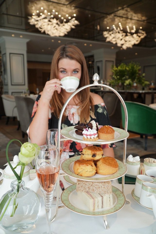 A woman enjoys a traditional afternoon tea in London