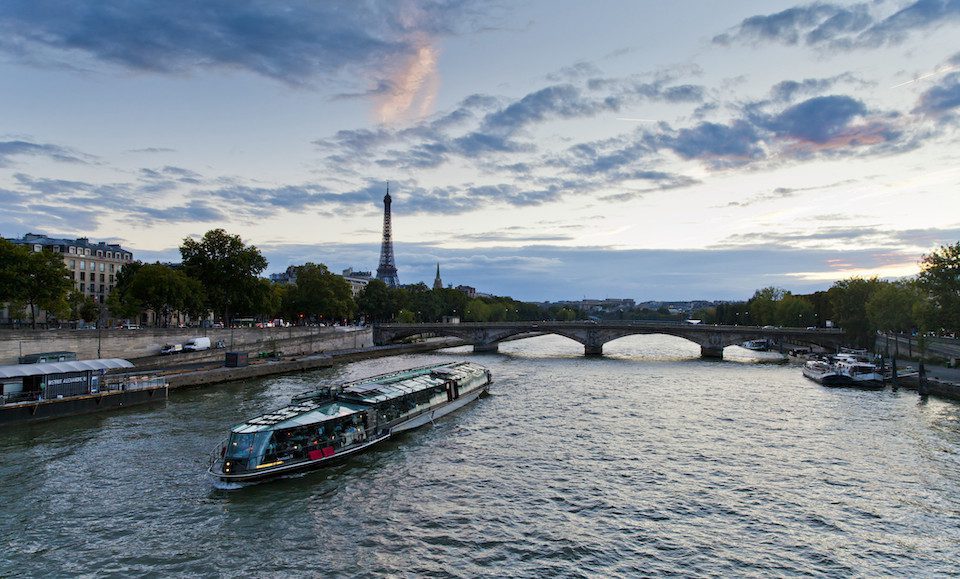 A boat cruises down a river in Paris, France