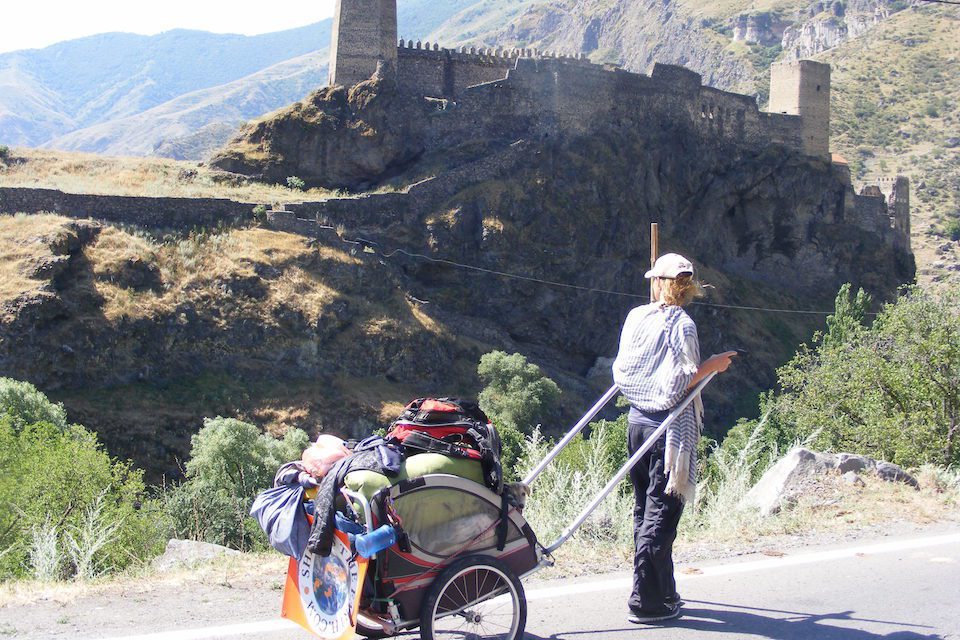 Angela Maxwell with her cart in front of a fortress