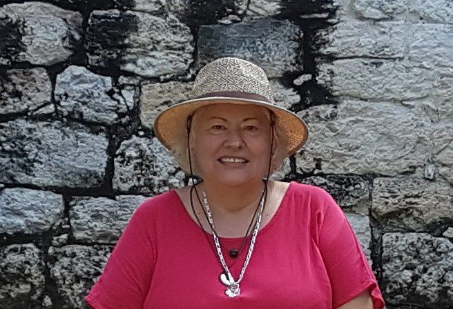 woman in pink shirt and hat