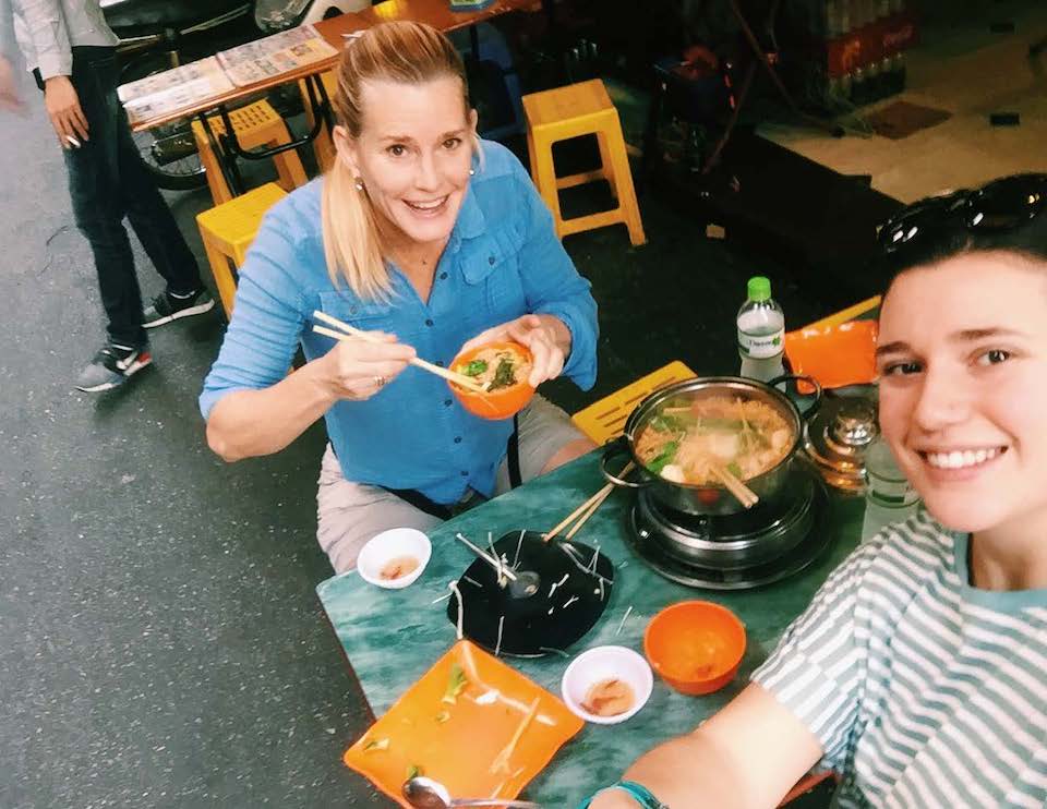 Two women eating noodles in Vietnam