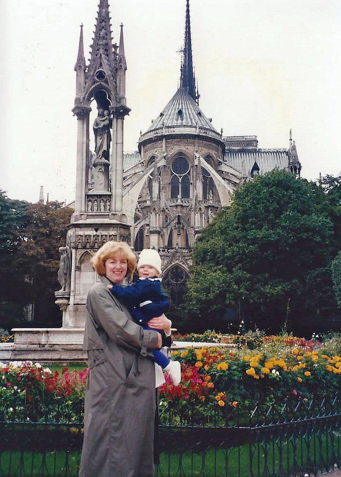 A mother holding her young daughter in Paris