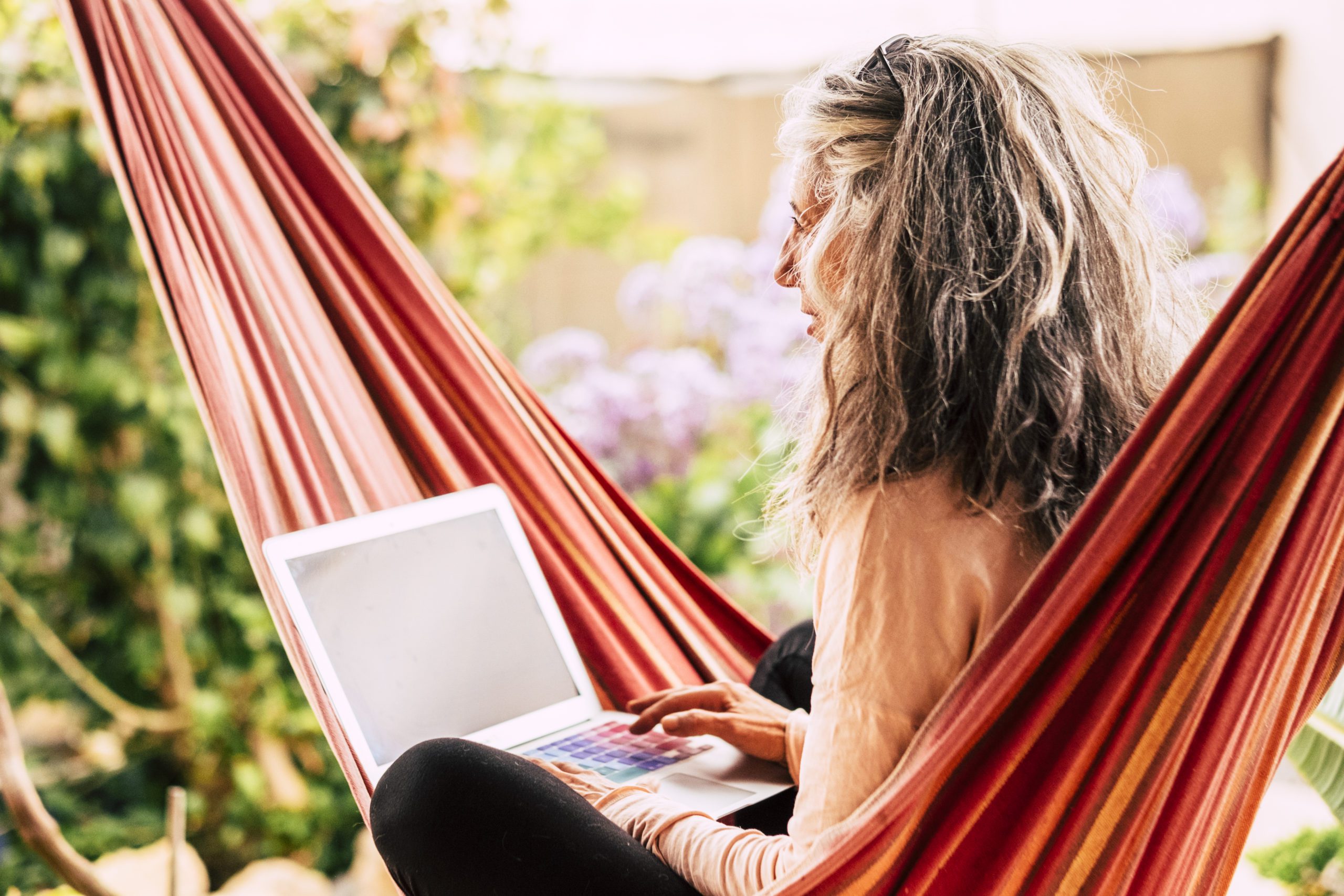 woman in hammock with laptop