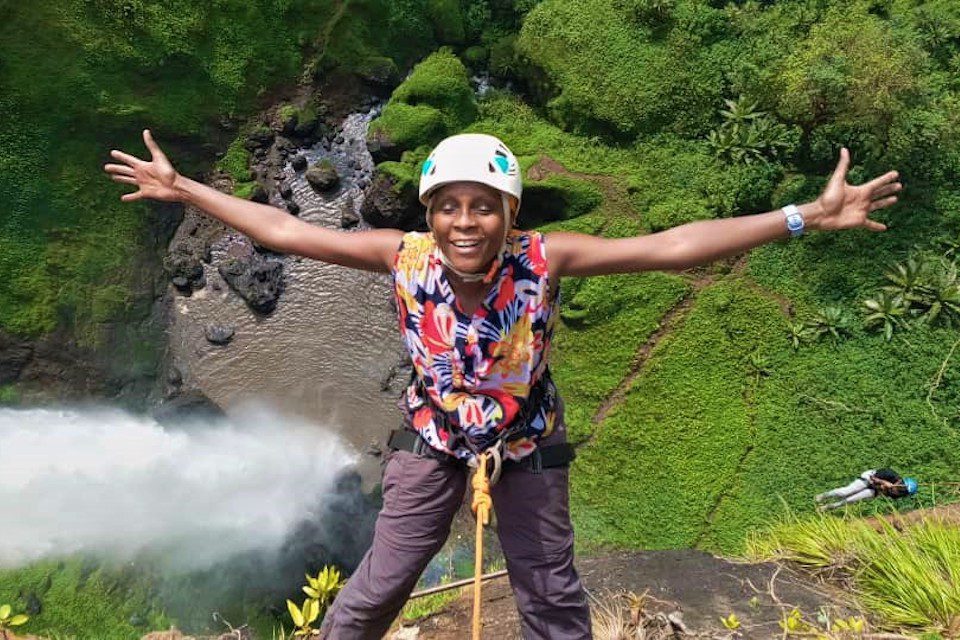 Maria Kamau abseiling at Sipi Falls, Uganda