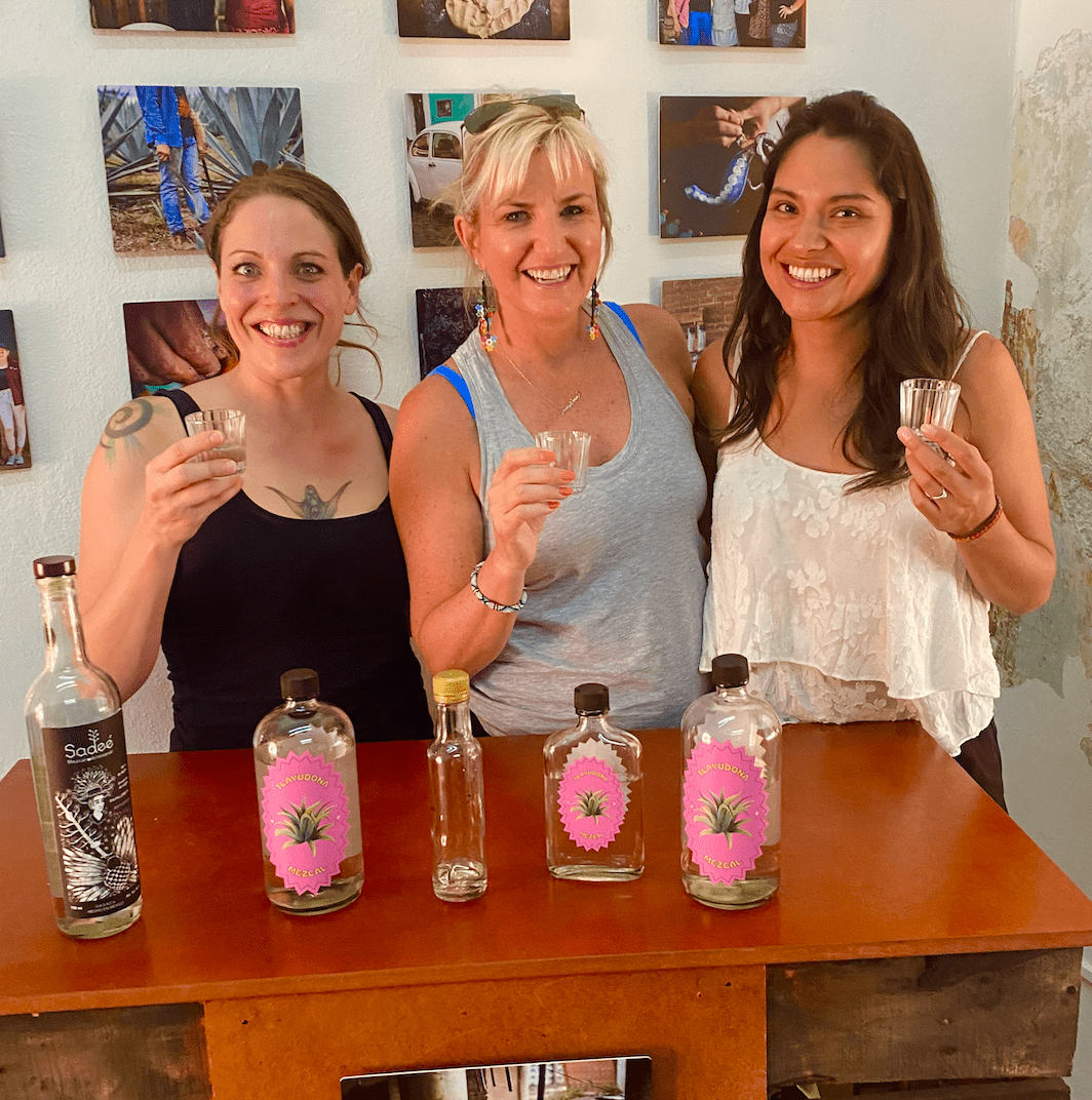 three women tasing mezcal in mexico