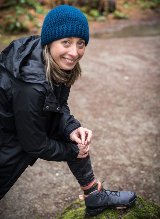 woman smiling with hiking boots