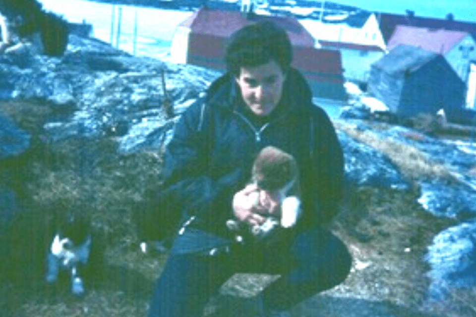 woman kneeling with a puppy