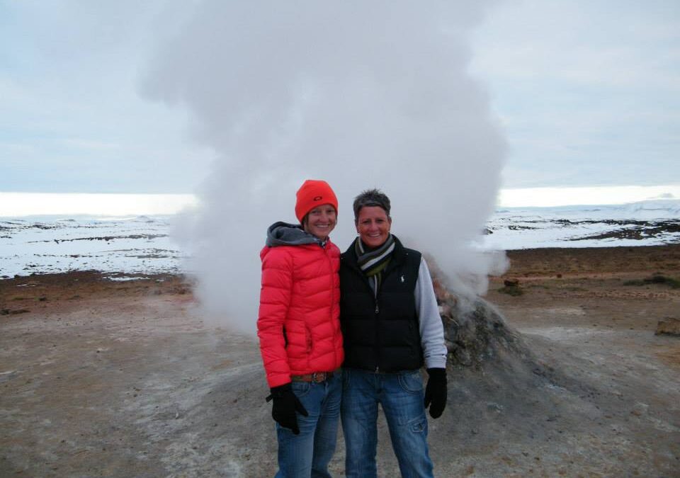 two women in front of a geyser in Iceland