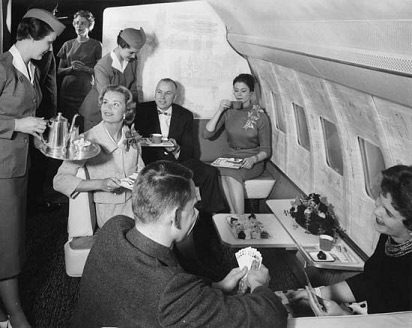 A black and white photo depicting guests enjoying a flight in the 1950s