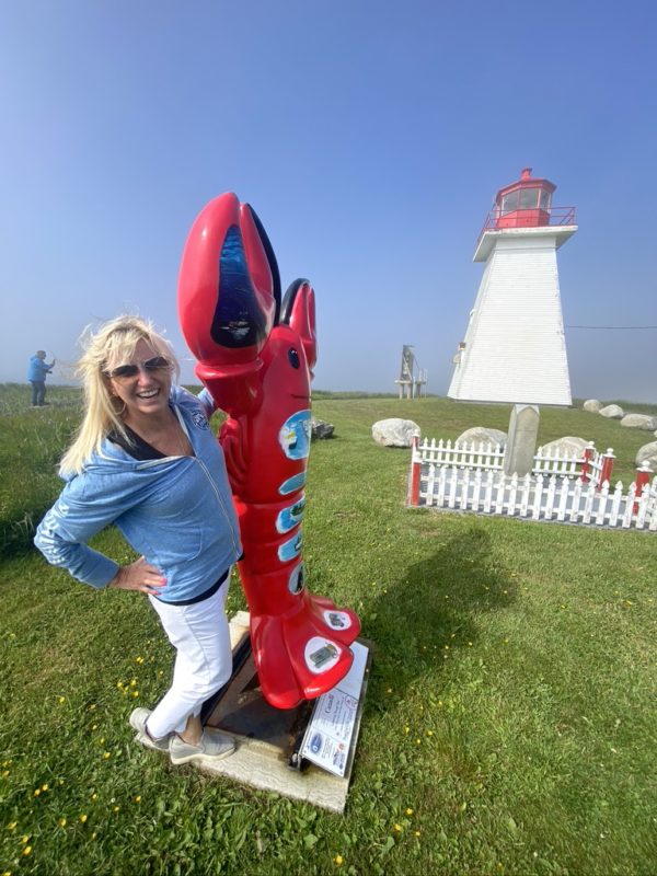 Carolyn poses with a red lobster mascot in Nova Scotia
