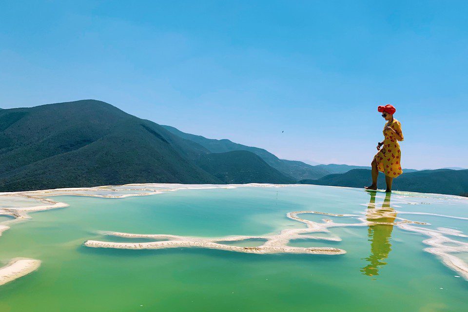 A woman walks across Hierve el Agua, Oaxaca