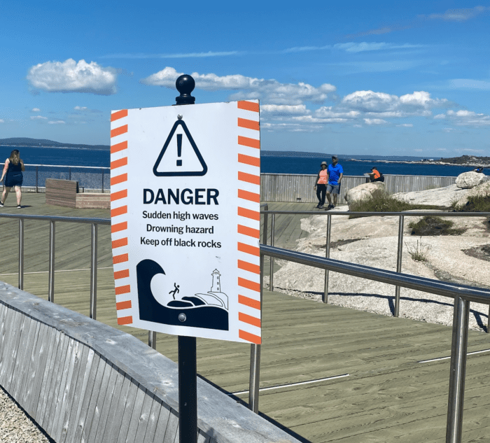 warning sign near wooden deck