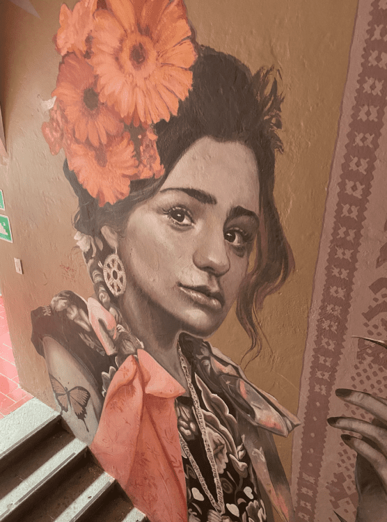 Graffitit of a woman with flowers in her hair at the Selina Hostel Oaxaca