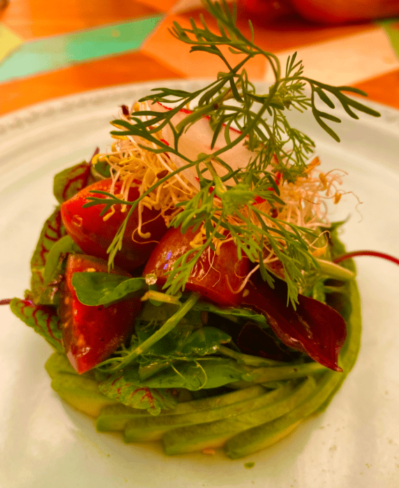 An avocado dish with tomatoes and garnish in Oaxaca