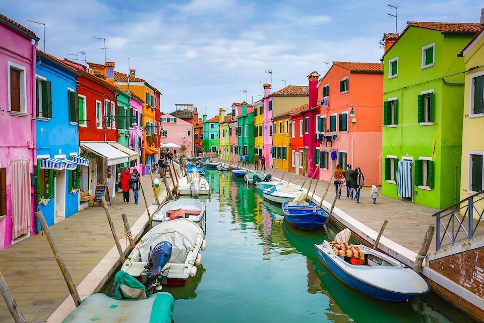 Colourful homes line a canal in Burano, Venice, Italy