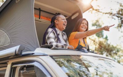 Friends enjoy vacation in the nautre with mini van - Mature women on a road trip with camper