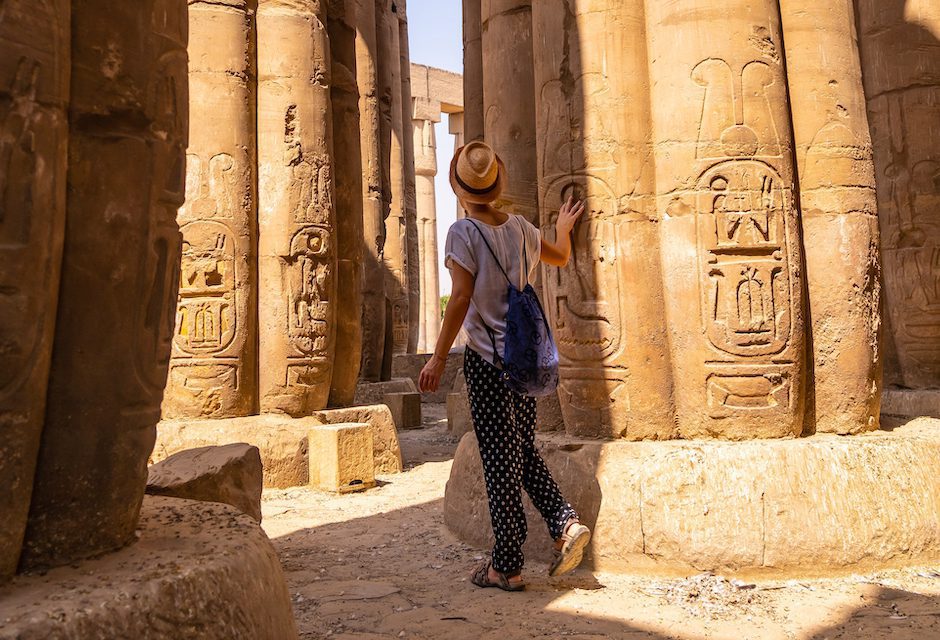 Woman touring a temple in Egypt,  one of the top places for solo travel in 2023 