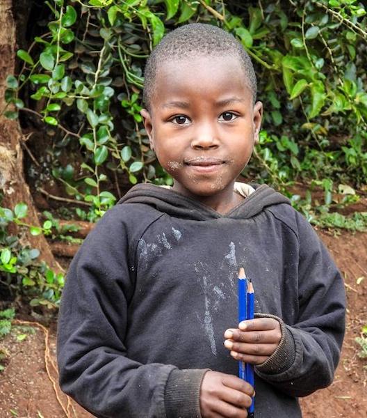 Tanzanian boy with pencils