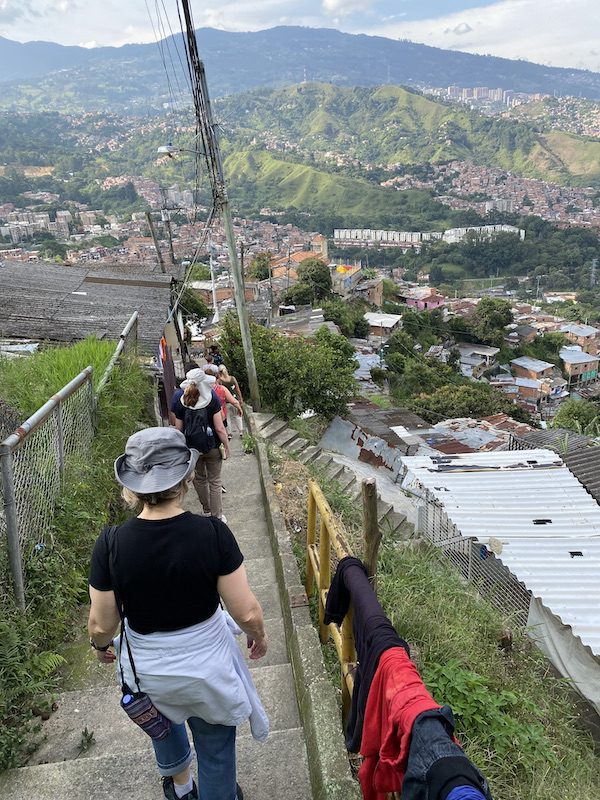 A group of people walk the narrow paths of Comuna 13 in Medellin, Colombia