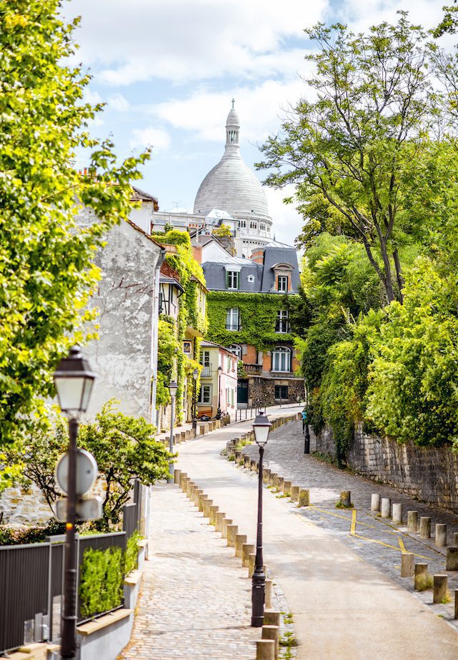 Cityscape view on the beautiful street with Sacred Heart cathedral on Monmartre hill in Paris