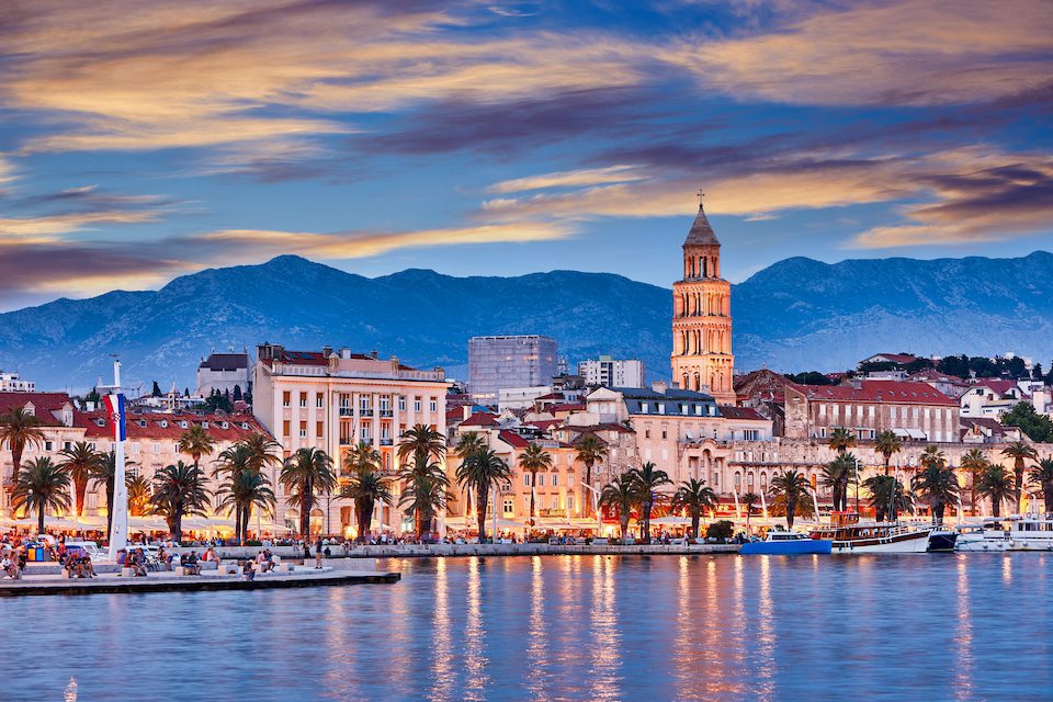 View of Split the second largest city of Croatia at night. Shore of the Adriatic Sea and famous Palace of the Emperor Diocletian. Traveling concept background. Mediterranean countries.