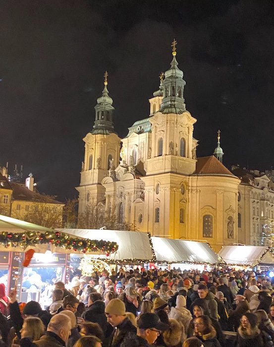 Crowds in the Prague Christmas Market at night