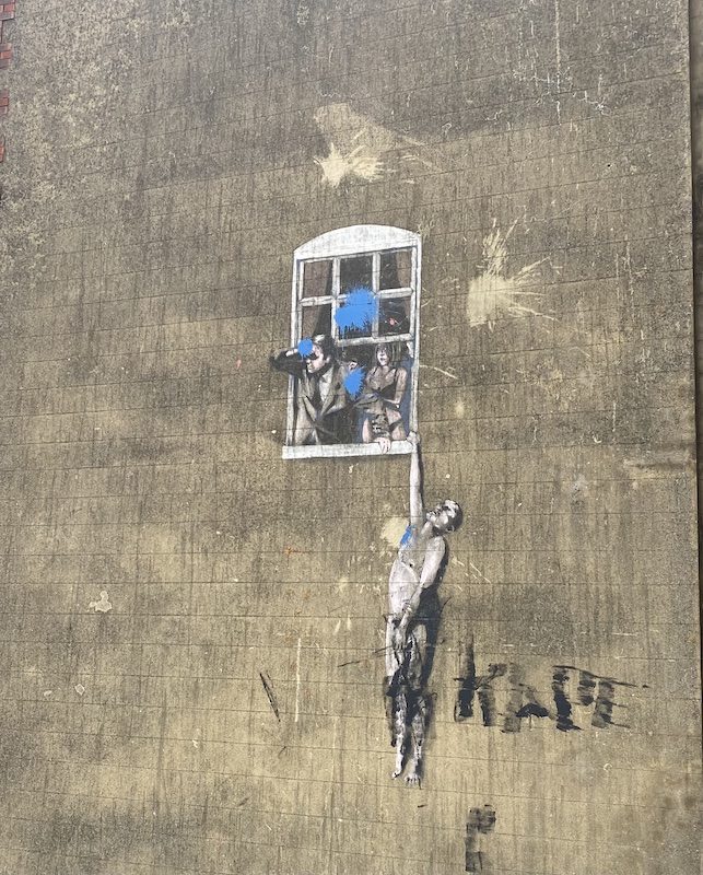 Banksy's Well Hung Lover street art in Bristol