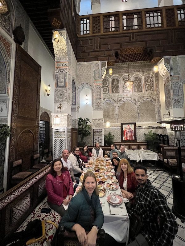A group enjoys dinner at Ryad Nejjarine in Fes, Morocco