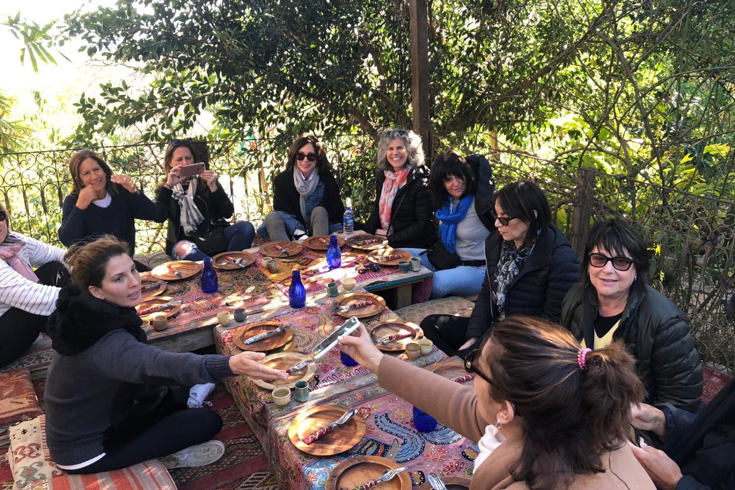 Group of women sitting around long table; Via Sabra