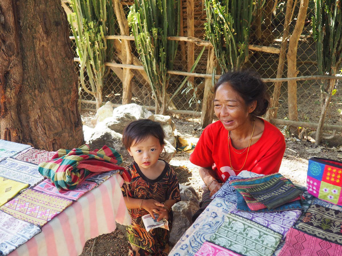 A woman with her son at a market in Laos