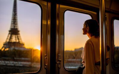 Woman enjoying view on the Eiffel tower from the subway train during the sunrise in Paris