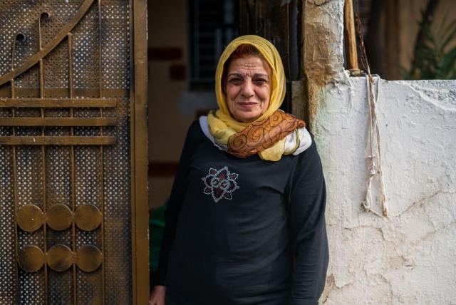 A woman wears a yellow headscarf in Jordan