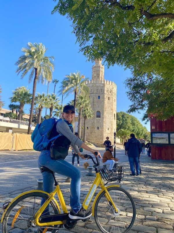 Carolyn Ray rides a bike around Seville, Spin
