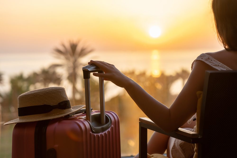 woman sunset suitcase