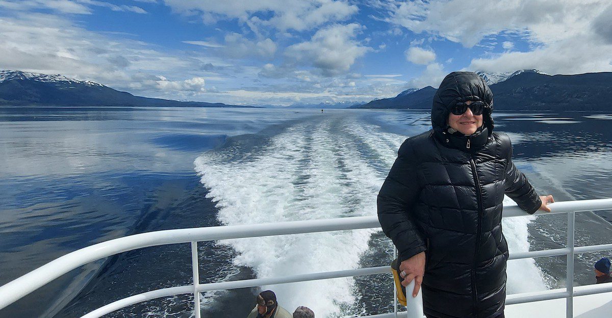 A woman stands on a ship departing Ushuaia heading to Antarctica