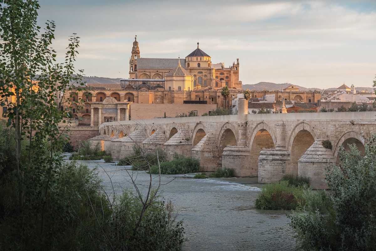 Cordoba skyline at sunrise with Old Roman Bridge and Mosque Cathedral