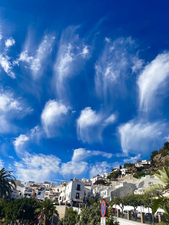 Picturesque clouds line a blue sky in Frigliana Town Spain