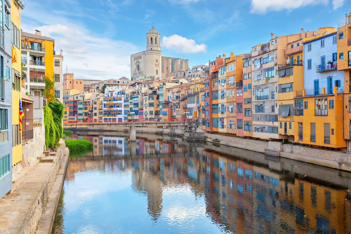 Girona, Spain. View of Cathedral and colorful houses reflecting in Onyar river