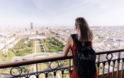 Tourist contemplating the city of Paris from the Eiffel tower